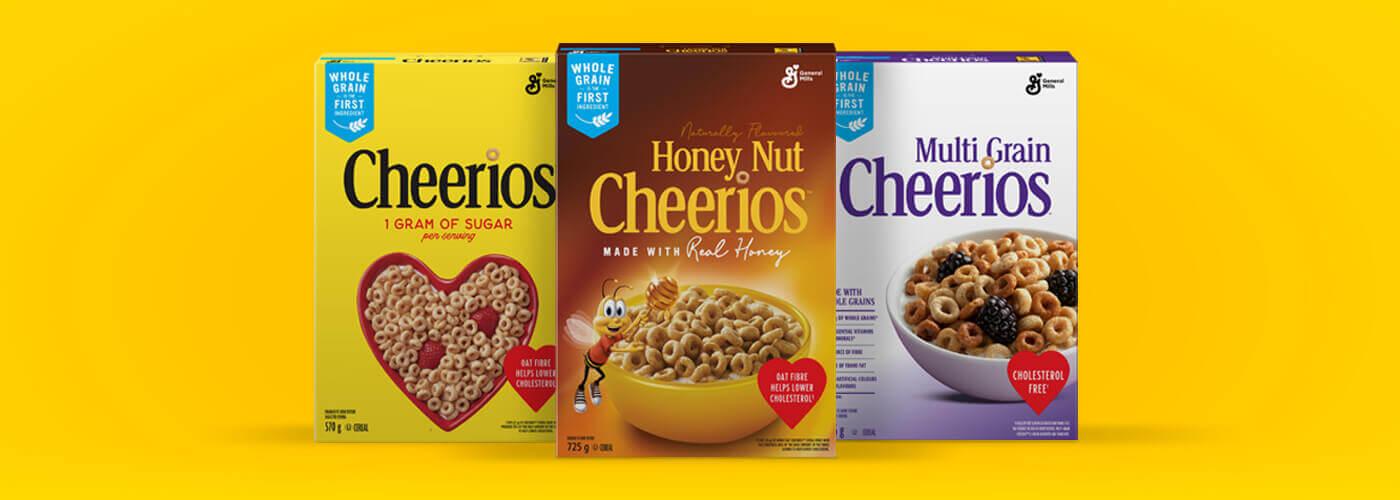 A family shot of the frontside of Original Cheerios, Honey Nut Cheerios and Multi-grain Cheerios, on a yellow background.