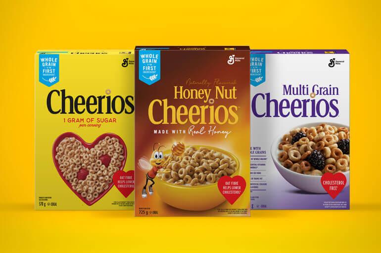 A family shot of the frontside of Original Cheerios, Honey Nut Cheerios and Multi-grain Cheerios, on a yellow background.